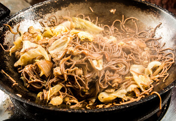 Frying buckwheat noodles or Soba in pan, in door  Chiangmai  Thailand