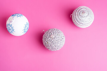 Christmas New Year composition. Gifts, silver and white ball decorations on pink background. Winter holidays concept. Top view