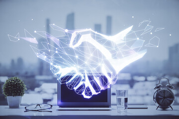 Desktop computer background in office and handshake hologram drawing. Double exposure. Pertnership concept.