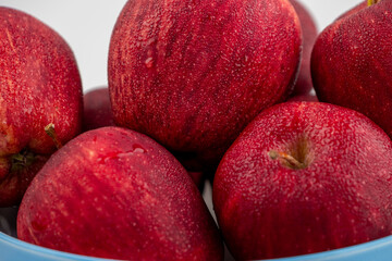 Close up of pile of red apple with clear water drop on 
shell surface texture pattern isolated, white background