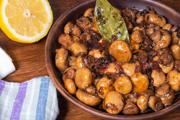 Vegan mushroom fricassee with garlic on a rustic background close-up - mushrooms with garlic, French cuisine.