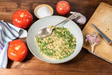 Provencal tomatoes - ingredients for cooking on a wooden table, top view