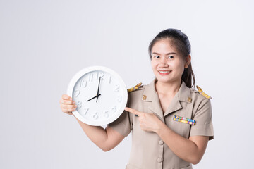 Thai teachers in official uniform holding clock showing time over eight o'clock