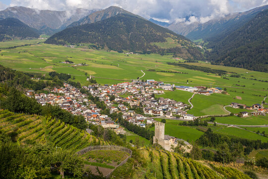 Aerial view of the historic center of Burgusio, Malles,  and the Prince's Castle, Val Venosta, South Tyrol, Italy