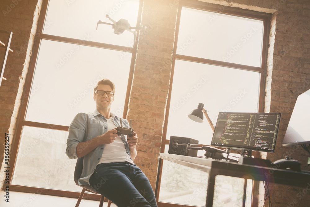 Poster portrait of his he nice attractive cheerful guy geek software developer expert controlling drone spe