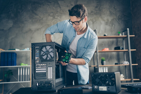 Portrait of his he nice attractive focused busy hardworking professional guy geek technician repairing hardware detail fixing order at modern loft industrial home office work place station