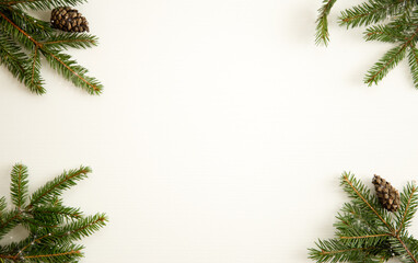 fir branches and cones on a white wooden background. Christmas composition. Frame. Place for text