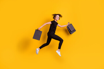 Full length body size profile side view of nice cheerful girl jumping running carrying packages...