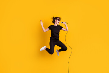 Fototapeta na wymiar Full length body size view of skinny funky talented popular girl jumping singing live hit isolated over bright yellow color background