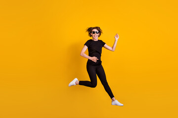Fototapeta na wymiar Full length body size view of attractive ecstatic carefree cheerful girl jumping having fun fooling isolated bright yellow color background