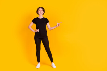 Full length body size view of attractive glad cheerful girl showing aside copy space solution isolated bright yellow color background