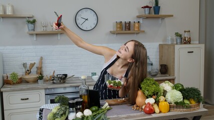 Blogger girl preparing food, taking photos on phone, making selfie to social media or video stories