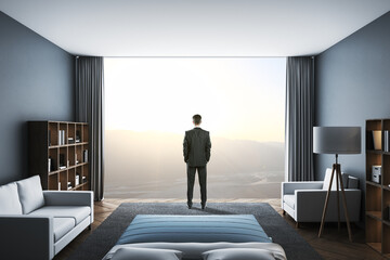 Businessman standing in clean living room with panoramic city view