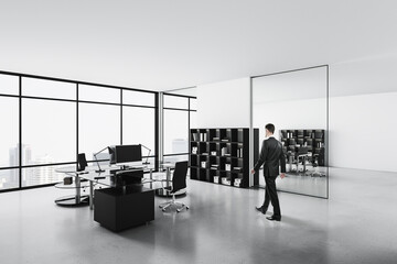 Obraz premium Businessman walking in office with computers