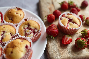 Homemade dessert - strawberry muffins with fresh berries on rustic background