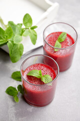 Homemade strawberry mousse in glasses with fresh mint leaves, summer berries dessert