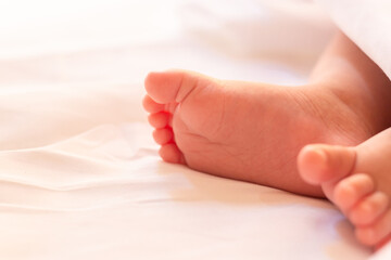 Fototapeta na wymiar Newborn baby feet on a white blanket.
