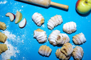 Homemade biscuits with apple filling. View from above on a blue background
