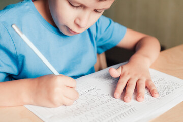 Close up of little boy doing writing practice. Children education concept.