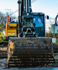 Large excavator with wide shovel on a dirty construction site. Close up.