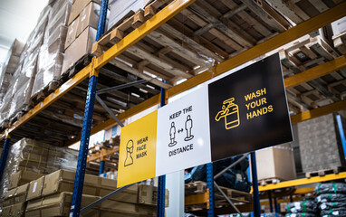 Safety signs on shelves indoors in warehouse, coronavirus concept.