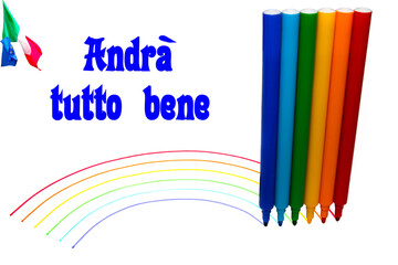 Dei pennarelli che disegnano un arcobaleno su un foglio bianco.