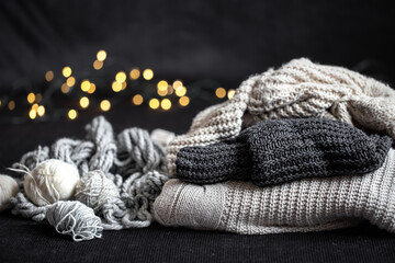 Plakat Composition with knitted items on a dark cozy background.