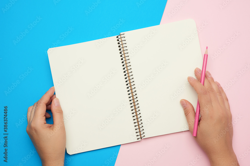 Poster two male hands holding open notepad with empty white sheets