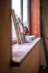 Plasterers  trowel tools propped up again the window ready to be used for a plastering job