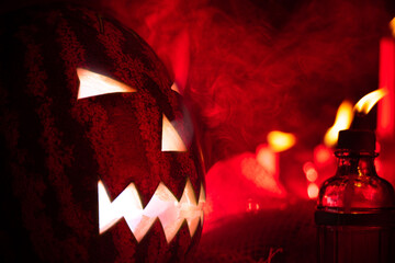 Jack pumpkin head from Brazil made with watermelon, low key portrait, horror portrait, red flash and a lot of smoke in the scene. Selective focus.