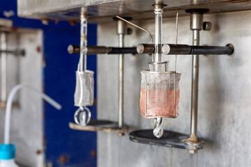 Electrolysis of copper sulfate in lab. It takes place in an electrolytic cell where electrolysis which uses direct electric current to dissolve a copper rod and transport the copper ions to the item.