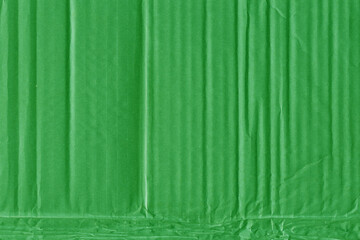 A green vintage rough sheet of carton. Recycled environmentally friendly cardboard paper texture. Simple and bright minimalist papercraft background.