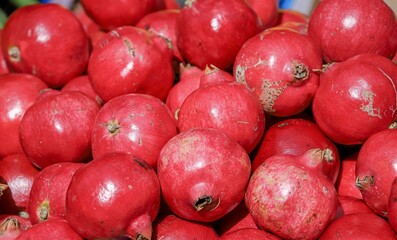 pomegranates -close-up of fruit and vegetables for sale at the market