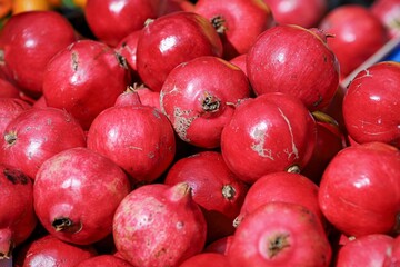 pomegranates -close-up of fruit and vegetables for sale at the market