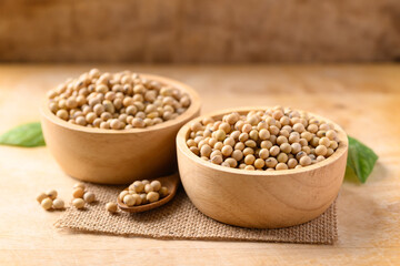 Soy beans in a bowl on wooden background