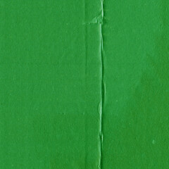 A green vintage rough sheet of carton. Recycled environmentally friendly cardboard paper texture. Simple and bright minimalist papercraft background.