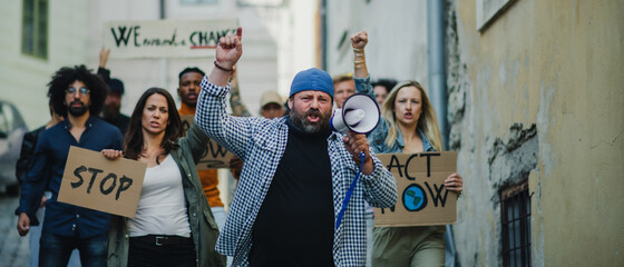 Group of people activists protesting on streets, strike and demonstration concept.