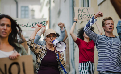Group of people activists protesting on streets, strike and demonstration concept.