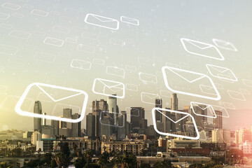 Double exposure of abstract virtual postal envelopes hologram on Los Angeles city skyscrapers background. Electronic mail and spam concept