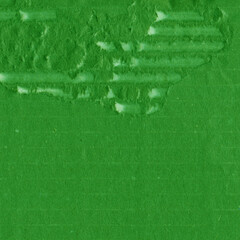 A green vintage rough sheet of carton. Recycled environmentally friendly cardboard paper texture. Simple and bright minimalist papercraft background.