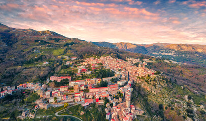 View from flying drone. Amazing spring cityscape of Novara di Sicilia town. Aerial morning view of...