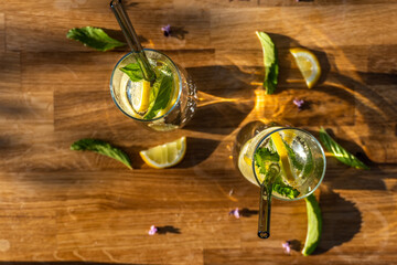Homemade lemonade, in glasses and with fresh lemon and mint.
