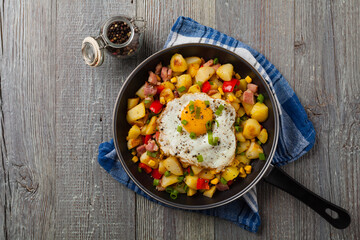 Traditional American hash with fried eggs. Top view.