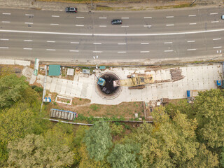 Aerial drone view. Metro construction site near the road through the forest in Kiev.