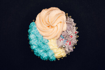 Cupcake with icing on black background