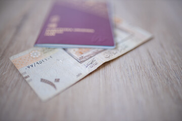 Ten Saudi Riyals Bill Partially Inside a Blurry Sweden Passport