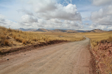 Fototapeta na wymiar Lonely dirt road near Tinajani canyon in peruvian Altiplano between Puno and Cusco in South America's Andes.
