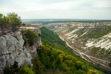 View of the valley from the top of a rocky cliff. Limestone canyon in Bakhchisarai. 