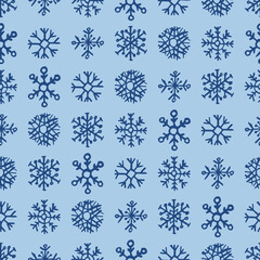 Seamless background of hand drawn snowflakes