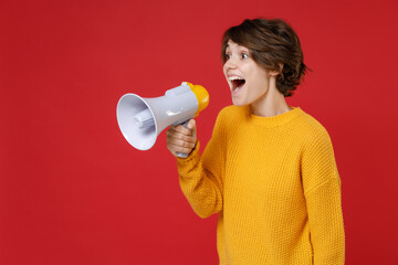 Excited cheerful funny beautiful young brunette woman 20s wearing casual yellow sweater standing...